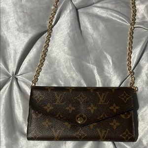 LV wallet with pink interior.